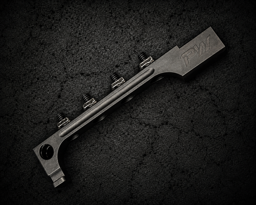 PsychWard Labs Harpoon M-LOK AK bayonet adapter with four mounting screws on a dark concrete background